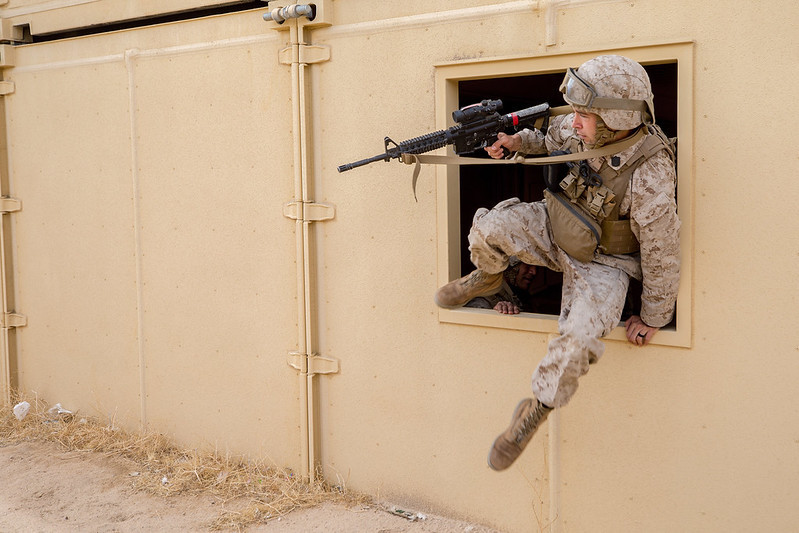 Hospital Corpsman 2nd Class Zachary Knueven maneuvers through a window during Integrated Training Exercise 2-21, Twentynine Palms, CA. Photo: US Navy.