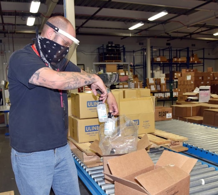 A supply technician prepares personal protective equipment shipments