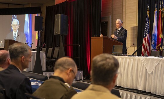 Nick Guertin delivers keynote address from a podium