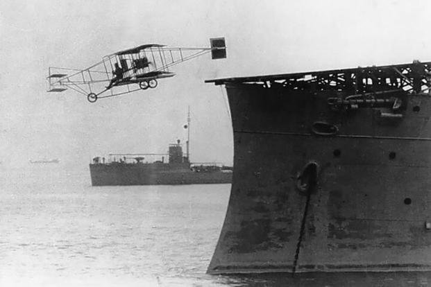 Eugene Ely flies his Curtiss pusher biplane from the USS Birmingham in Hampton Roads, Virginia, on Nov. 14, 1910
