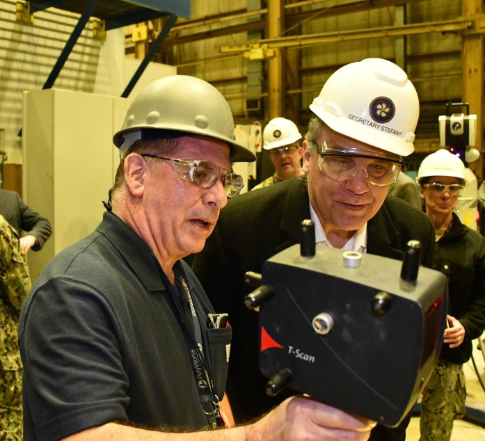 Engineering Tech Joe Santola, left, demonstrates to the U.S. Navy’s Jay Stefany how the Naval Foundry and Propeller Center uses laser tracking