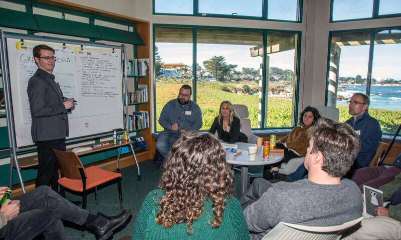 Students and faculty from NPS and Stanford gather in a classroom