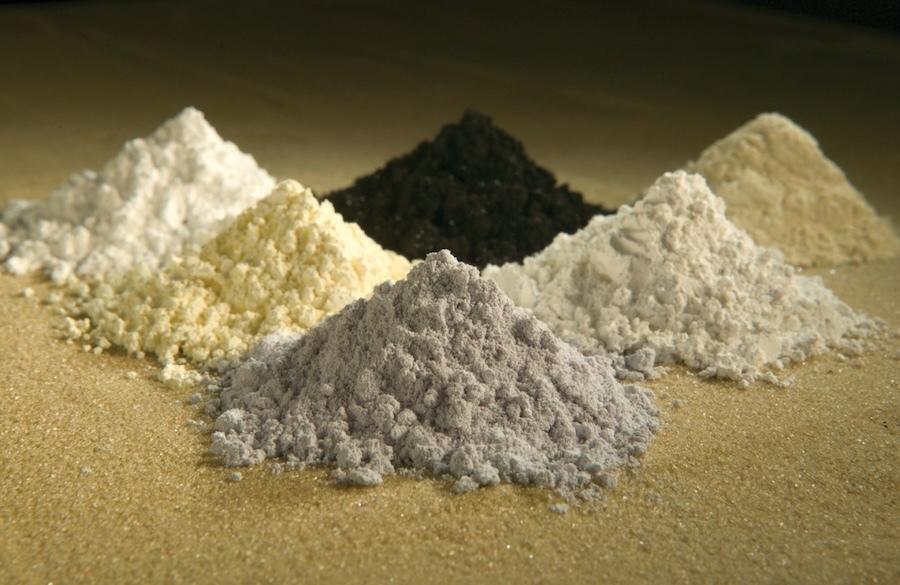 close-up of six piles of different grey, white, and black powders