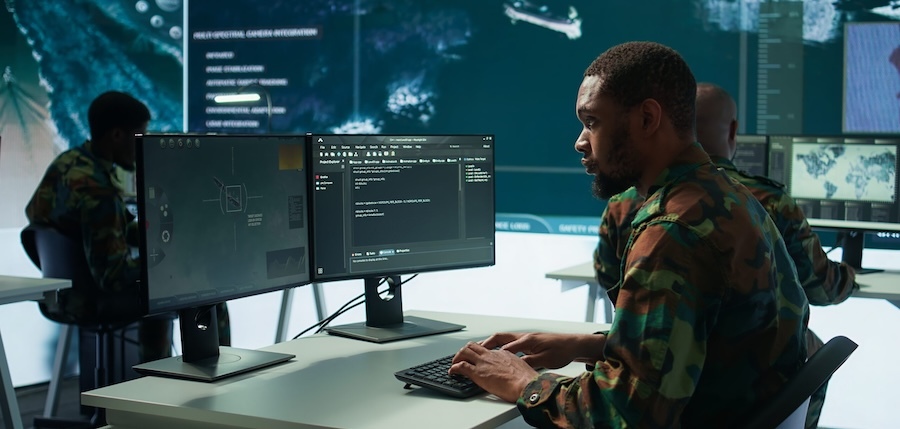 solider in fatigues working at a computer