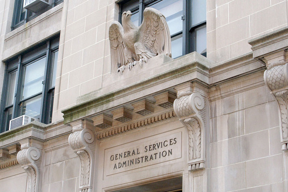 white stone building with eagle over door, General Services Administration written above the lintel