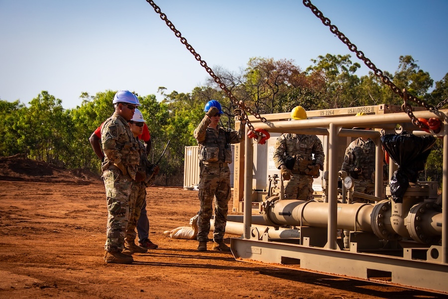 soliders standing around heavy equipment