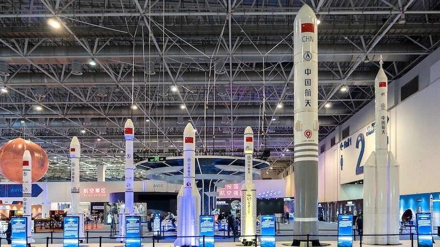 seven rockets with Chinese lettering displayed in an indoor space