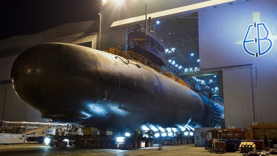 submarine emerging from an indoor shipyard