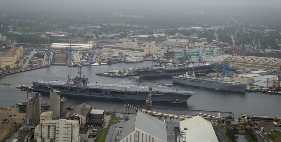 aircraft carriers navigating through a shipyard