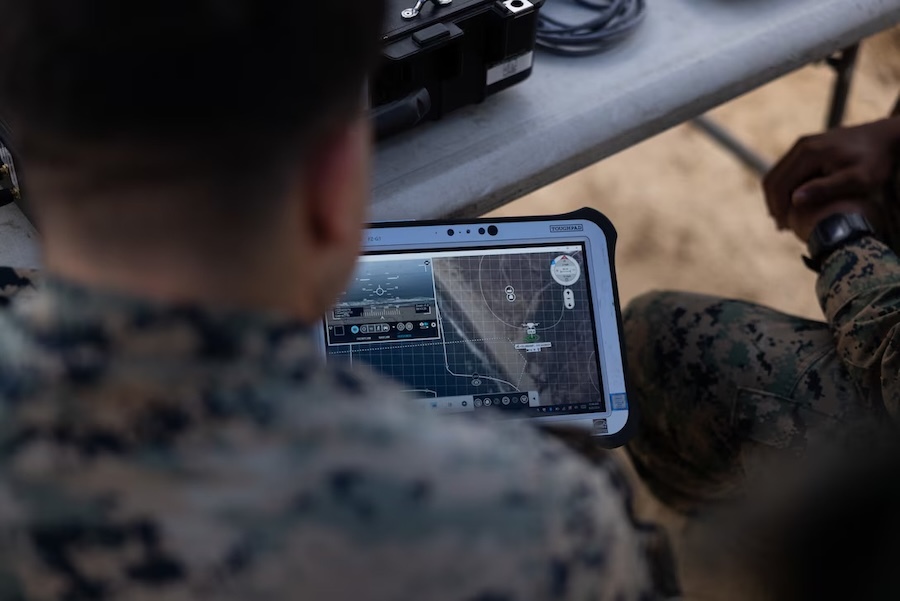 tablet display seen over the shoulder of a uniformed marine
