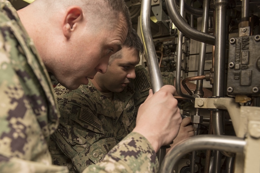 two men working on machinery