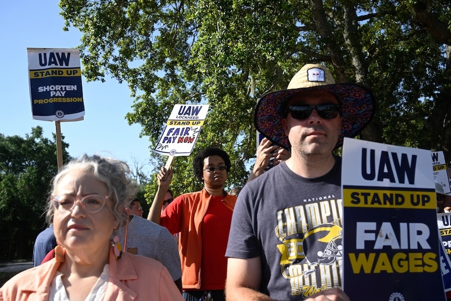 men and women holding UAW signs