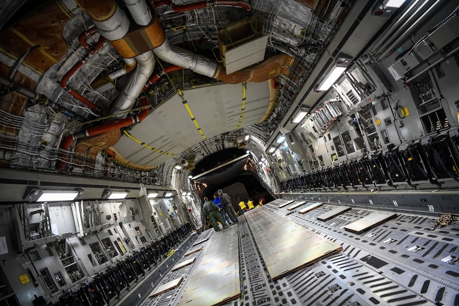workers in the interior of a large cargo plane