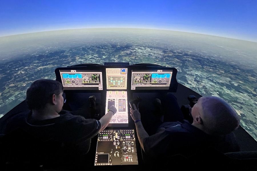 two people in a cockpit, looking out at the curvature of the earth