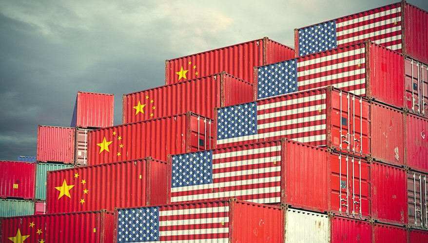 stacked cargo containers painted with US & Chinese flags