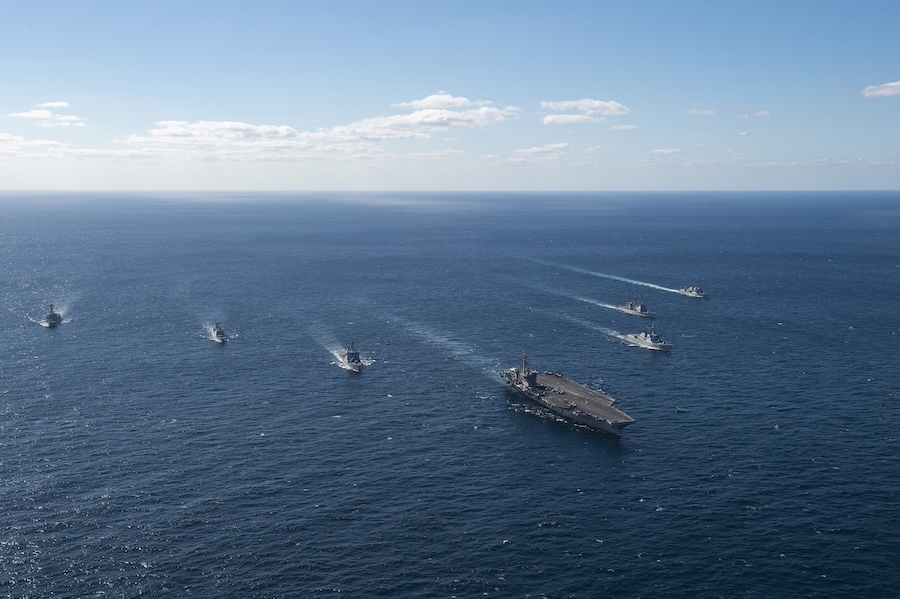 warships steaming across an open ocean 