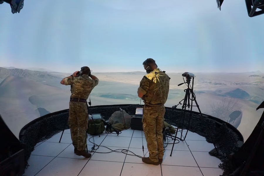 two soldiers on a platform look out over a dessert landscape