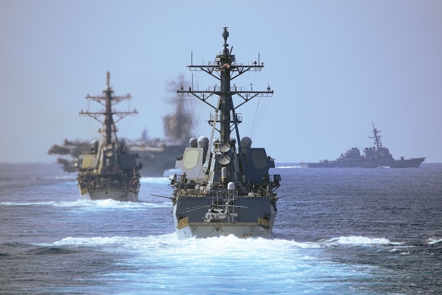 two destroyers headed away from camera