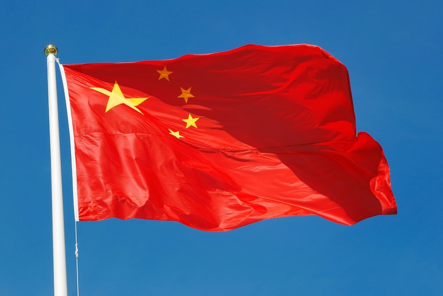 Chinese flag waving against a blue sky