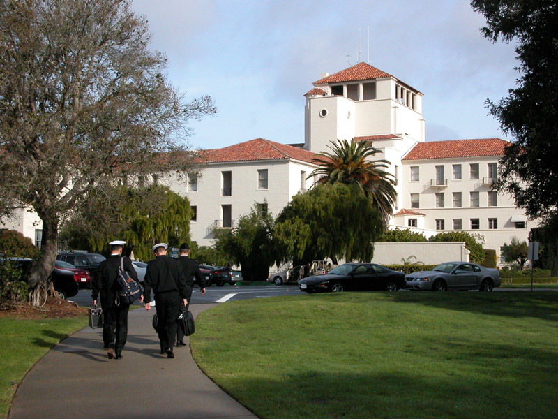Sailors walking toward an NPS campus building