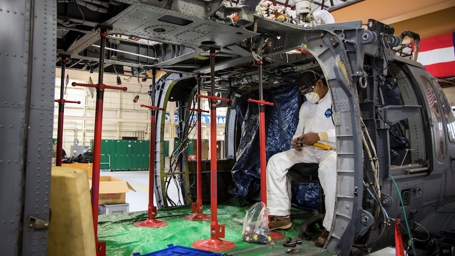 man in aircraft shell inspecting tools