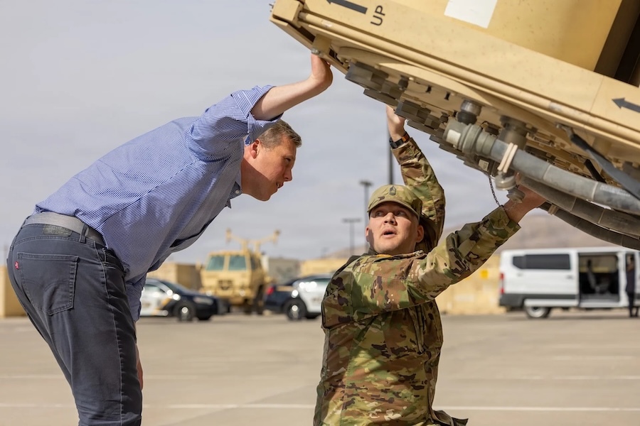 two men examing large equipment