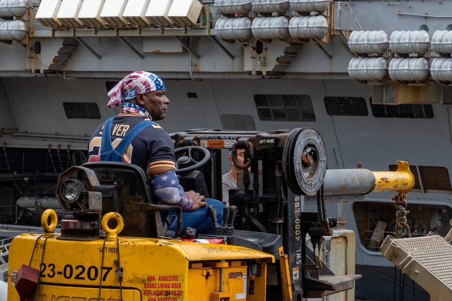 man driving marine equipment aboard a ship