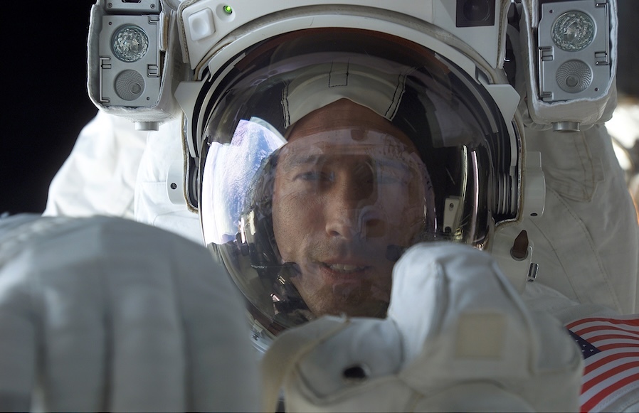closeup of astronauts face inside a space suit's helmet