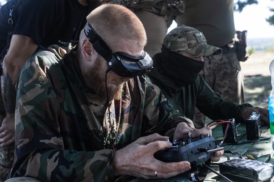 a man in a headset works a remote control