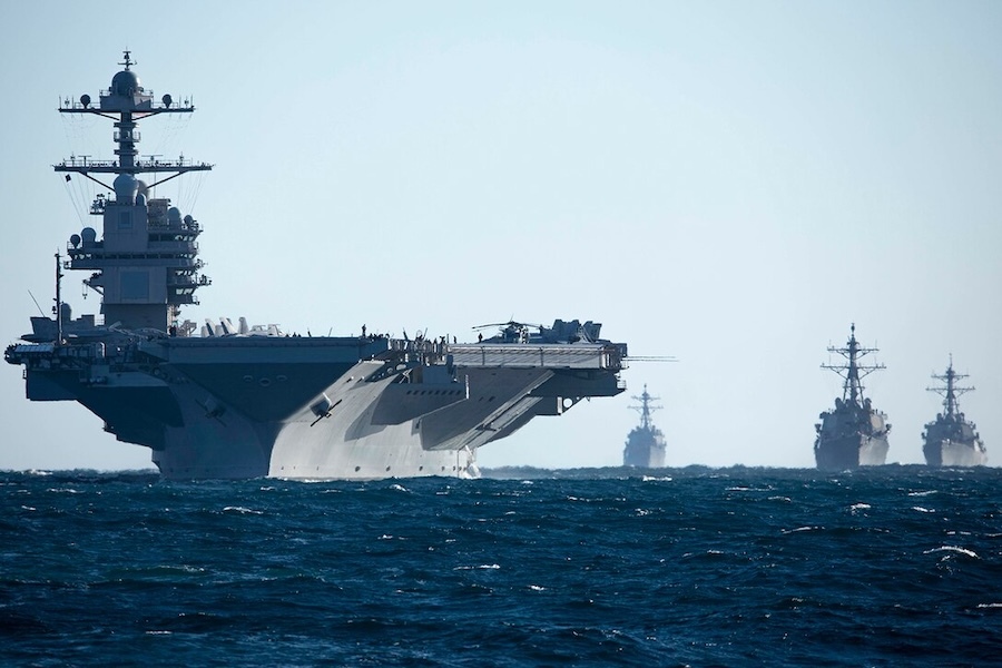 aircraft carrier and three ships at sea
