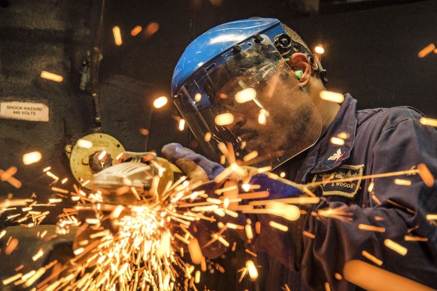 man grinding metal, sparks flying