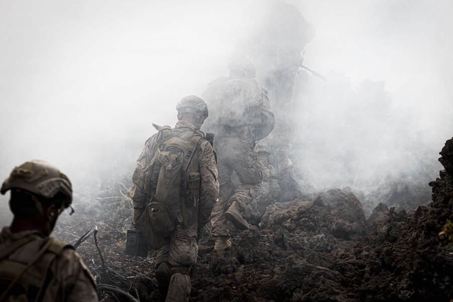soldiers walk though mist