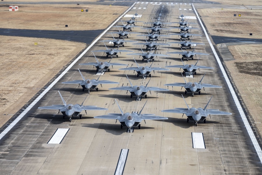 aircraft lined up in rows on a runway