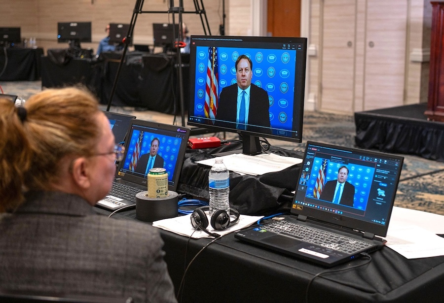 Michael Duffey delivering an address on screen