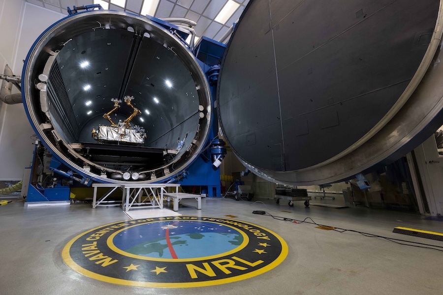 round chamber with open door, robot inside, NRL seal on floor in front