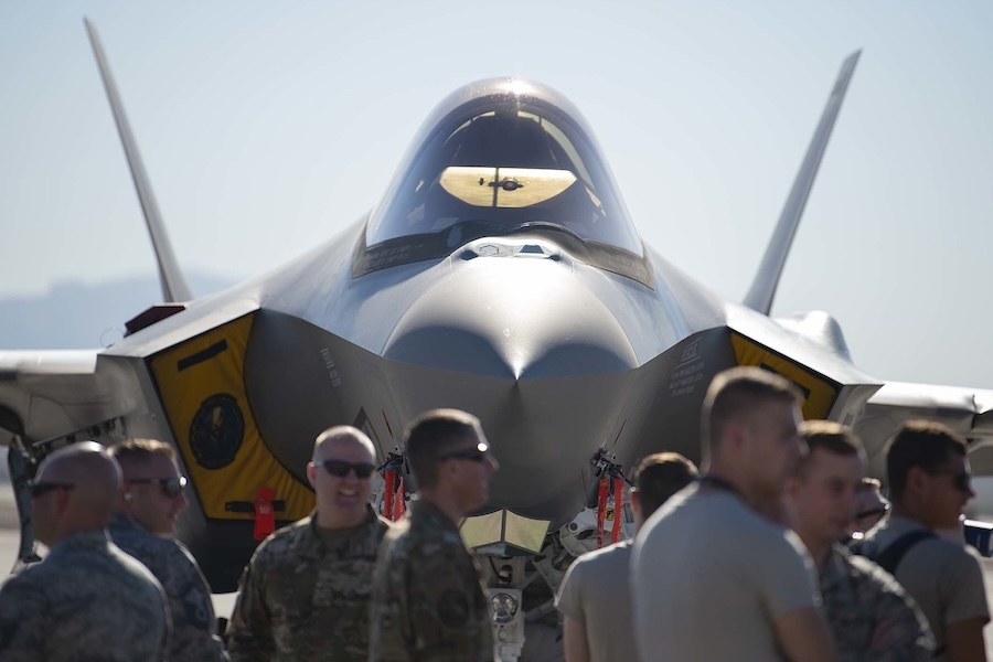 front view of F-35 with people standing in front of it
