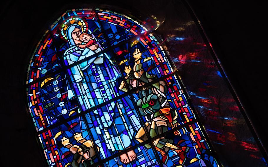 stained glass window featuring the Virgin Mary and American paratroopers.jpg