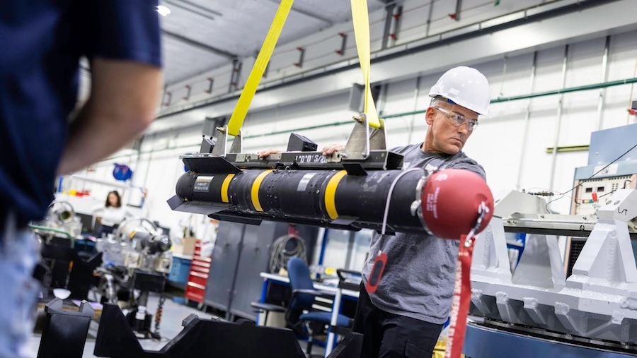 man in a hardhat working with a missile