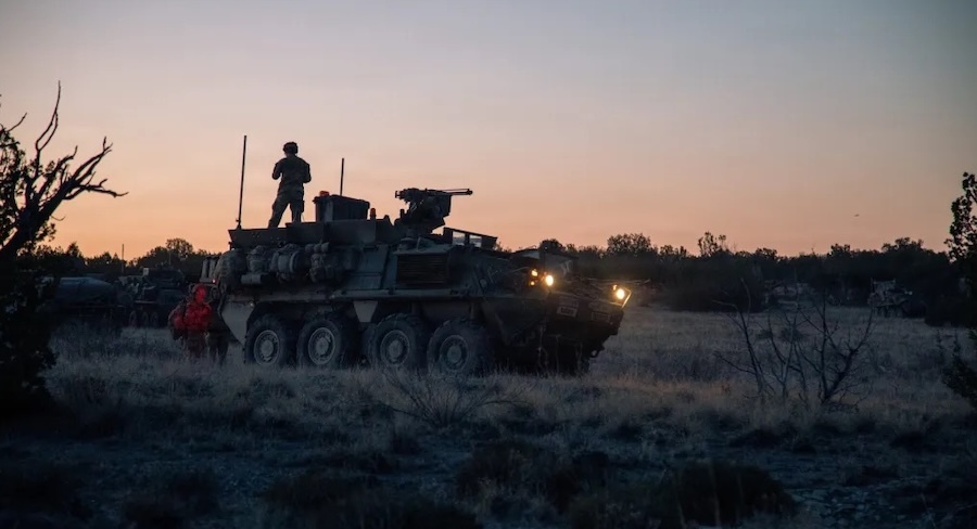 silhouette of a man standing on a tank