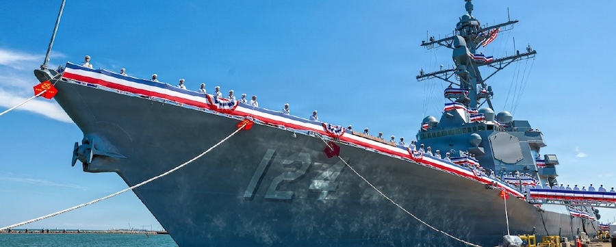 prow of a Navy shipped decked with red white and blue bunting