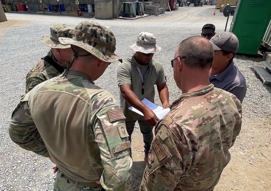 soldiers standing in front of a man with a clipboard