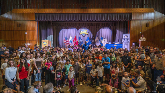 Victor Glover posed with large group of children and teens