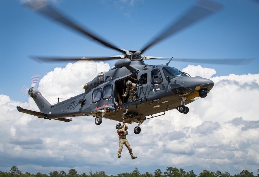 MH-139A Grey Wolf helicopter with soldier hanging from the doorway