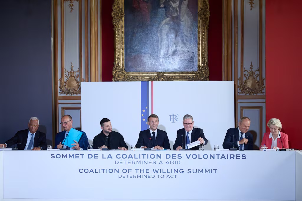 world leaders seated at a white table