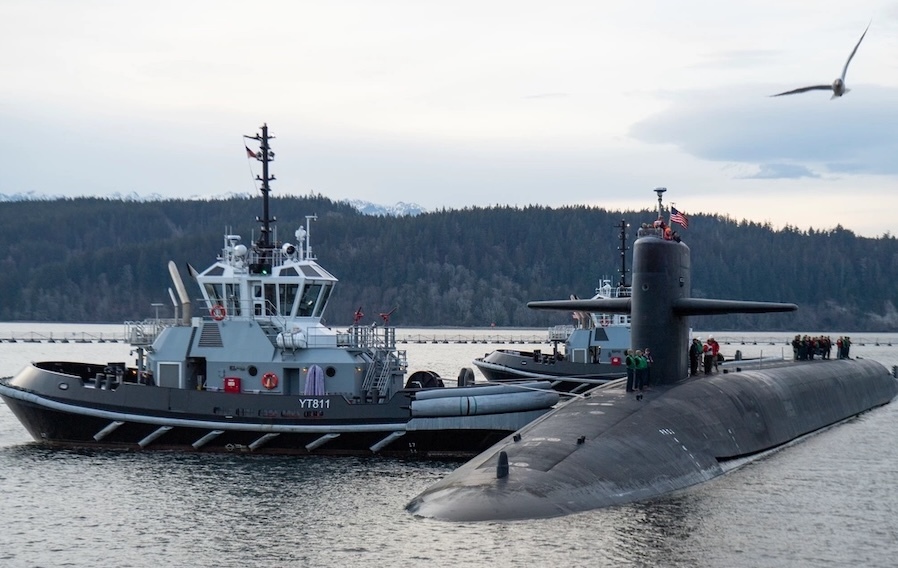 ship alongside a surfaced submarine