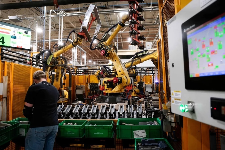 person with back to camera working on an assembly line