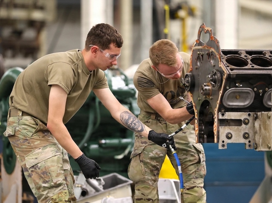 Two men working on a piece of machinery
