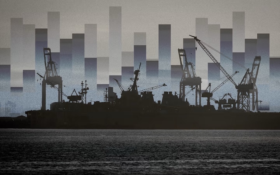 silhouette of a ship in front of a shipyard