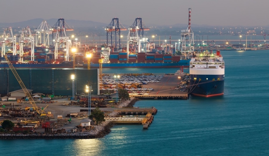 Industrial cargo port with gantry cranes loading a container ship