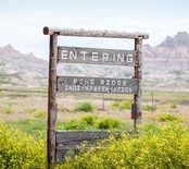 A sign reading "Entering Pine Ridge Indian Reservaion"